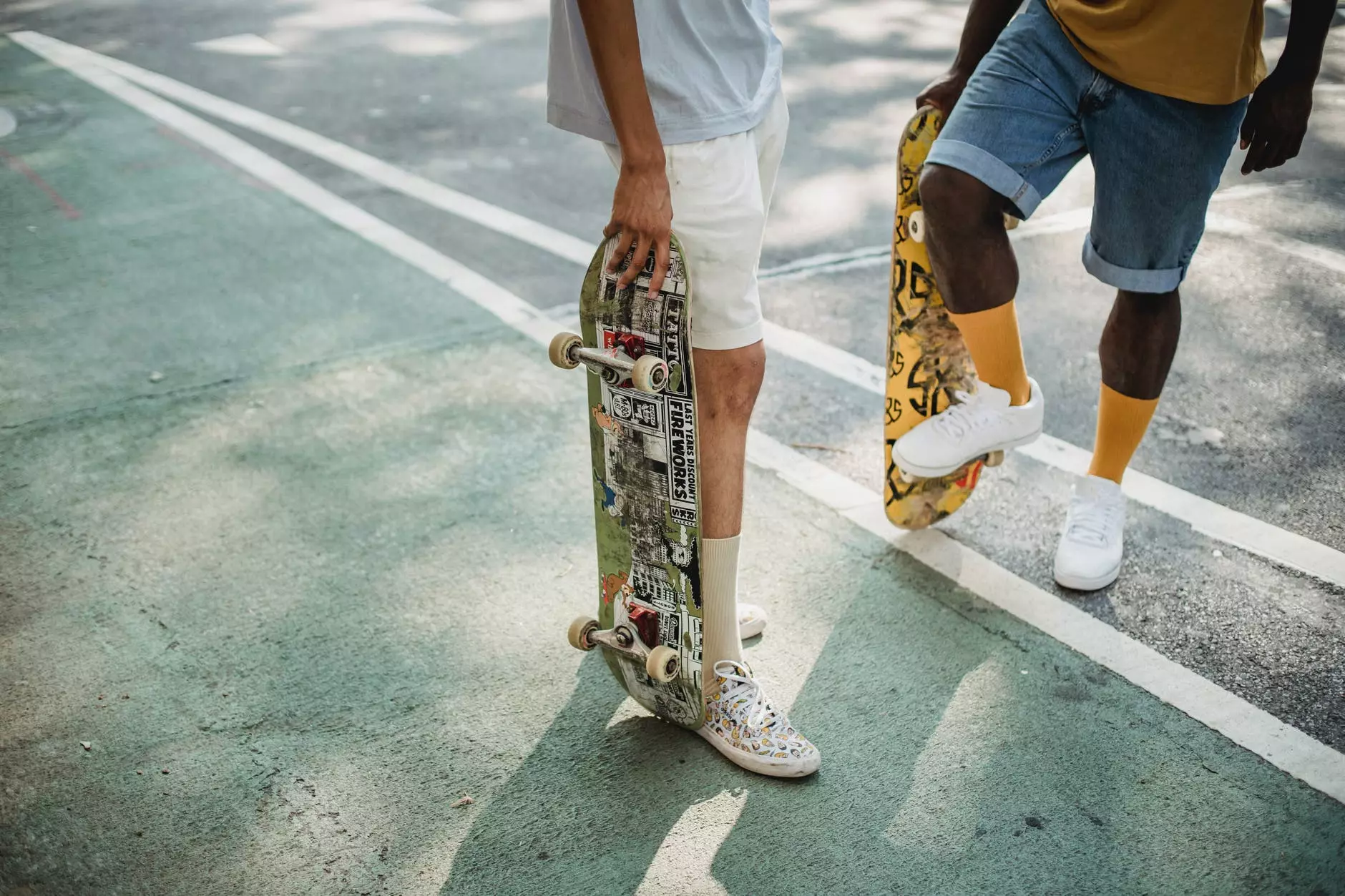 recorta a diversos patinadores de pé con monopatíns na estrada de asfalto. Foto de Budgeron Bach en Pexels.com